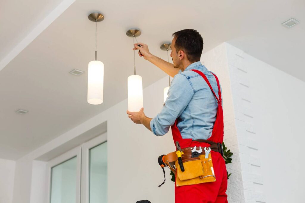 electrician hanging light